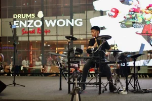 Enzo Wong playing electronic drums at live performance from Legato Music